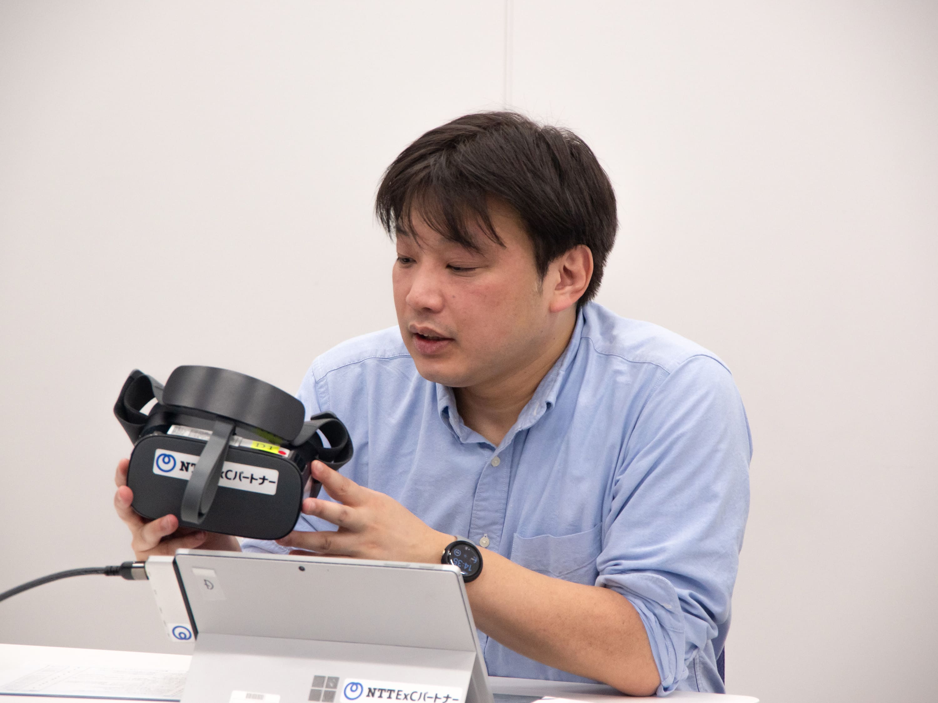 写真：VRゴーグルを手に持って話している様子の浅野さん